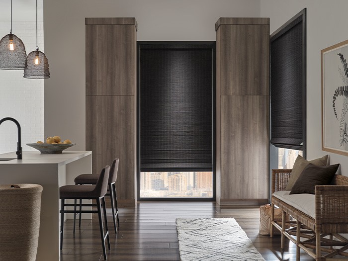 Kitchen with windows featuring Provenance® Woven Wood Shades with PowerView® Automation.